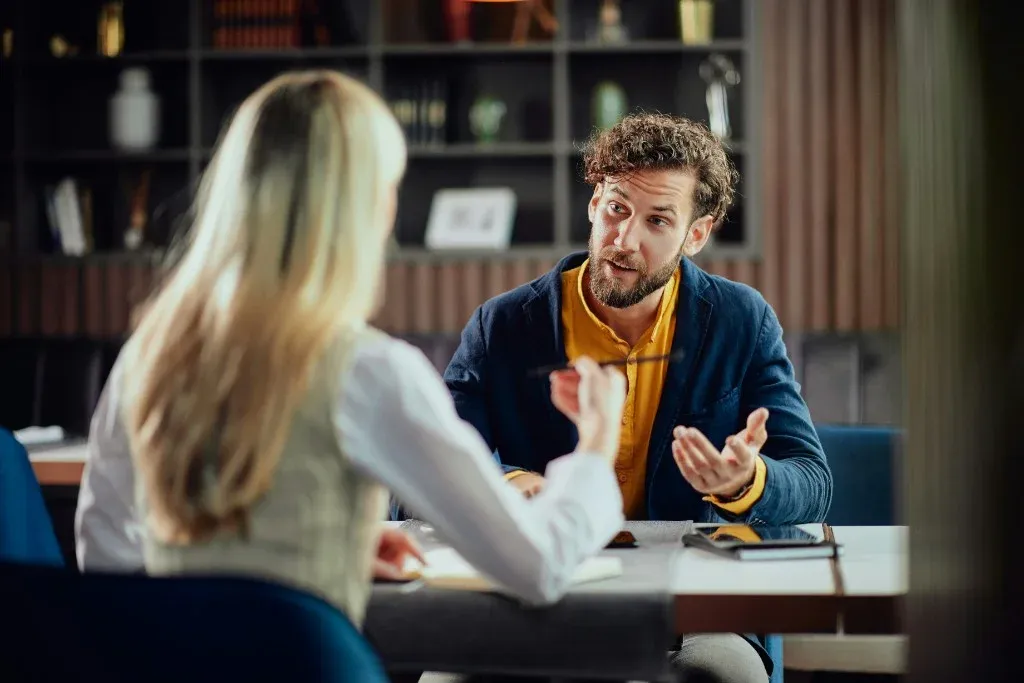 Professional presenting charts and documents during a business meeting