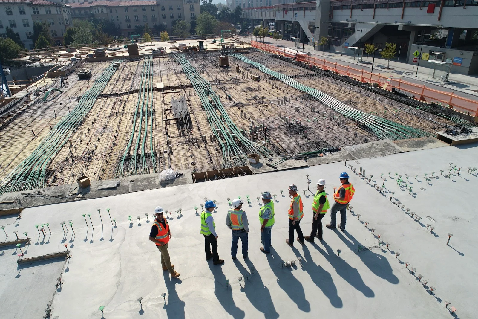 Hard hats and blueprints on a job site table