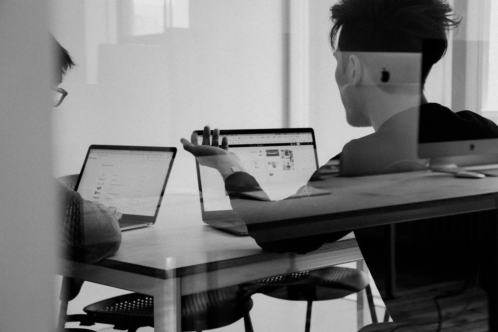 Designers reviewing work together at a monitor