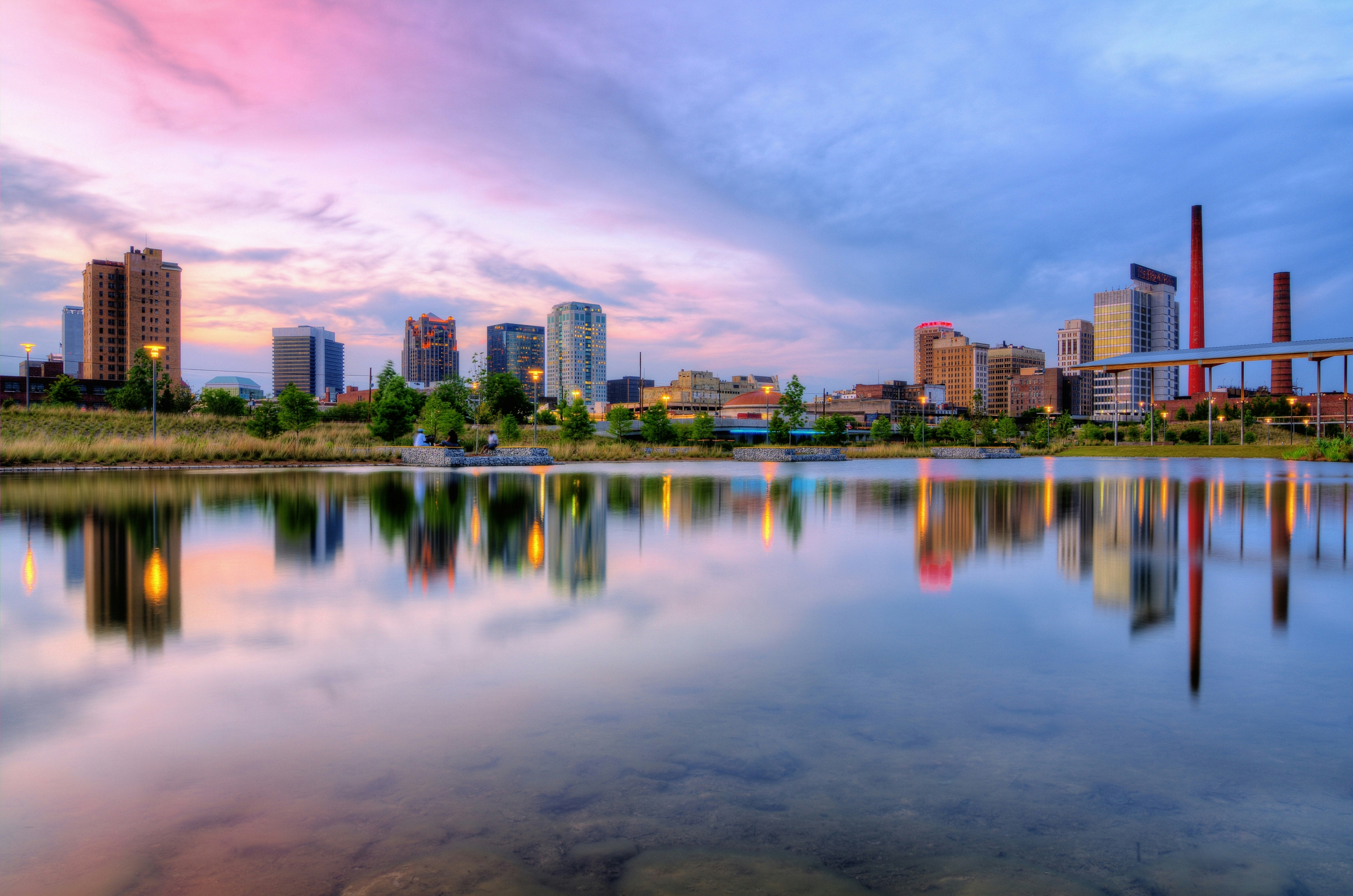 Birmingham skyline at sunset reflected in water at Railroad Park
