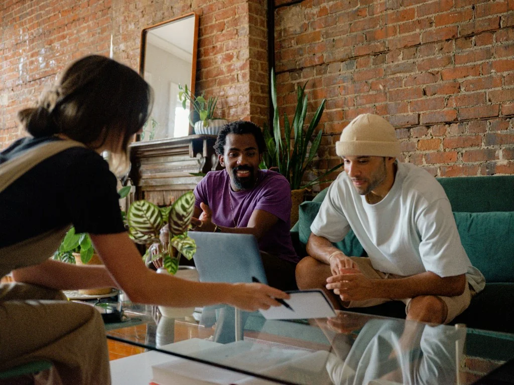 Team collaborating around a laptop during a hiring meeting